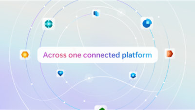 Three colleagues in discussion around a table.