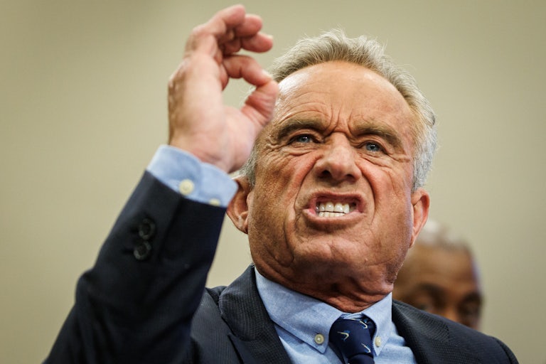 Robert F. Kennedy Jr. holds up his arm and gnashes his teeth. He's very angry