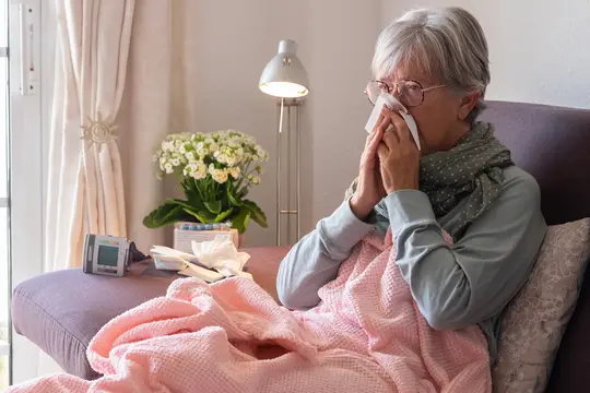 photo of woman blowing nose