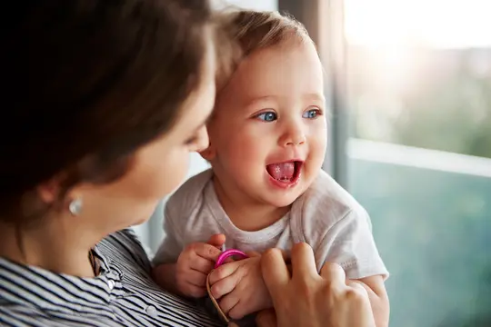 photo of mother holding baby