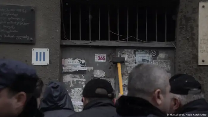 A crowd gatherss near an evicted home in Tbilisi