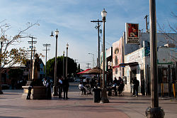 Mariachi bands wait at the plaza