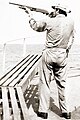 Image 16A merchant seaman aboard a fleet oil tanker practices target shooting with a Remington 870 12 gauge shotgun as part of training to repel pirates in the Strait of Malacca, 1984 (from Piracy)