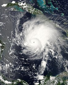 Hurricane Emily with a well-defined eye is located south of Jamaica.