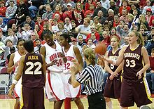 Fans in the stands behind then team-captain and others discussing a dispute