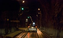 Tunnel interior, with train tracks in roadway and safe house visible