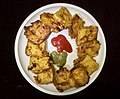 Bread pakora, made by deep-frying bread slices coated with gram flour.