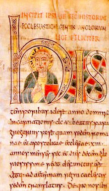 Illuminated manuscript with a forward facing man in the middle of the large H. Man is carrying a crozier and his head is surrounded by a halo.