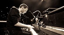 Johnny McDaid playing on a piano.