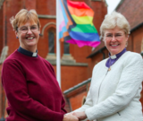 Anglican priests Catherine Bond right, and Jane Pearse sporting collars in casual wear shortly after completing the Sacrament of Matrimony.