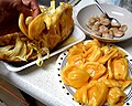 Extracting the jackfruit arils and separating the seeds from the sweet flesh.