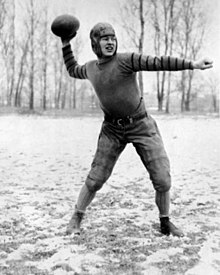 A black and white image of a man preparing to throw a football