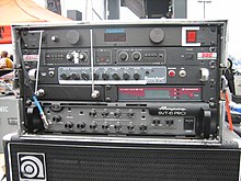 An equipment rack from a modern bass player's performance system is shown. Several electronic devices are mounted onto the equipment rack.