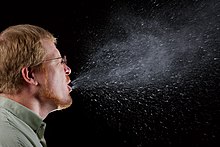 Cough/sneeze droplets visualised in dark background using Tyndall scattering