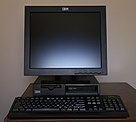 Black desktop computer with monitor on top and keyboard in front