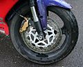 Modern motorcycle alloy wheel with inflatable tire and disc brake