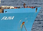 Somali pirates standing guard aboard the Faina.