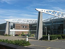 A picture of a two-storey building with two free-standing masonry piers on front