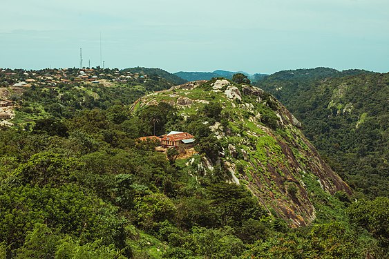 The Old House is one of the oldest structures on the Pilgrimage ground. It is believed it is over 100 years old. It was built with rocks and stones and it houses the Parish Priest and the Assistant parish priest. The Old House is surrounded by mountains and trees and from this view it sits alone. This shot of the house was taken from the top of the hill where the Cross is erected. Photograph: User:Iyanu omogbadegun