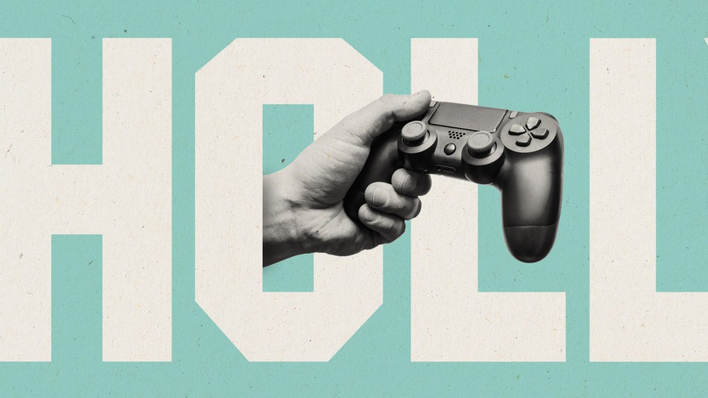 A hand holding a video game controller that is moving through the O in Hollywood in big letters.