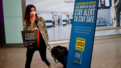 A newly arrived passenger wears a face mask at London's Heathrow airport. AFP