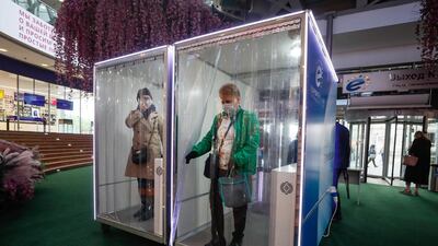 Customers walk through a disinfection cabin at entrance of the Evropeyskiy shopping Ñenter in Moscow, Russia. EPA