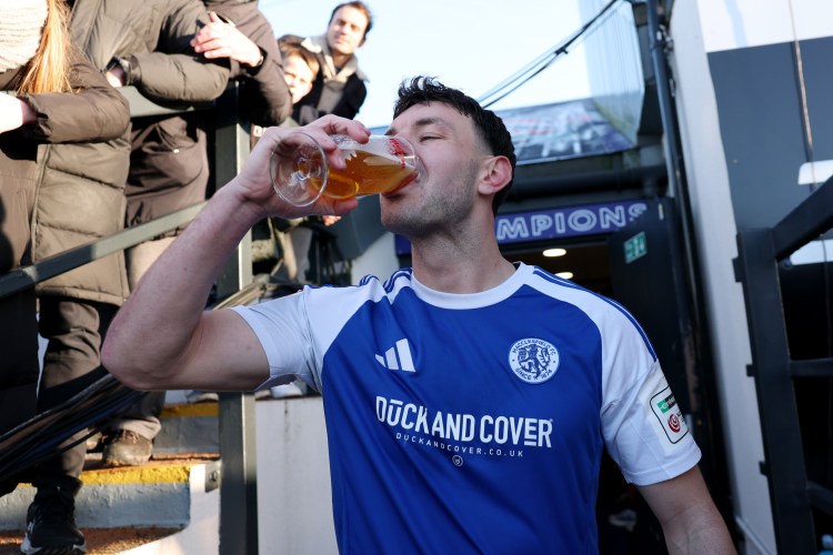 Sam Heathcote of Macclesfield drinking beer after his team's victory.