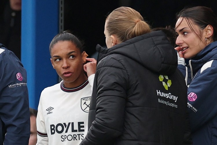 West Ham United's Estelle Cascarino is delayed coming on as a substitute due to her earrings.