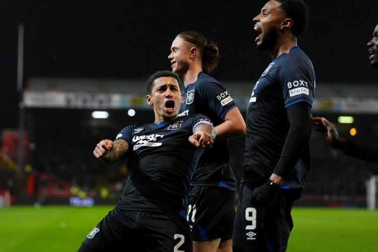 Rangers' James Tavernier celebrates with teammates after scoring his team's second goal.