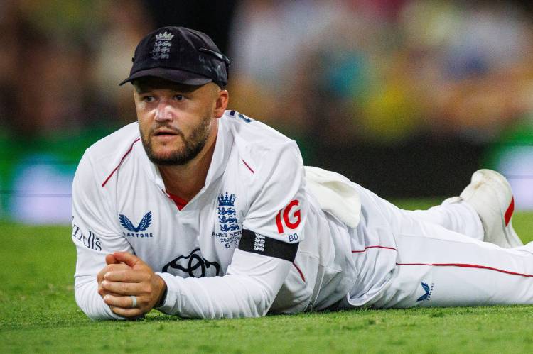 Ben Duckett lies on the grass after dropping a catch during the Ashes cricket Test.