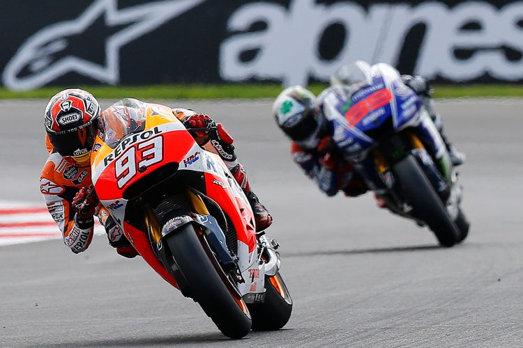 Honda MotoGP rider Marquez of Spain competes with Yamaha rider Lorenzo of Spain during the British Grand Prix at the Silverstone Race Circuit